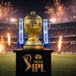 Golden IPL trophy displayed at M. Chinnaswamy Stadium in Bengaluru during IPL 2026 final with fireworks and packed crowd in background.