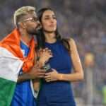 Indian cricketer Hardik Pandya celebrating with the Indian national flag during a stadium celebration, which later sparked a controversy regarding the Flag Code of India.