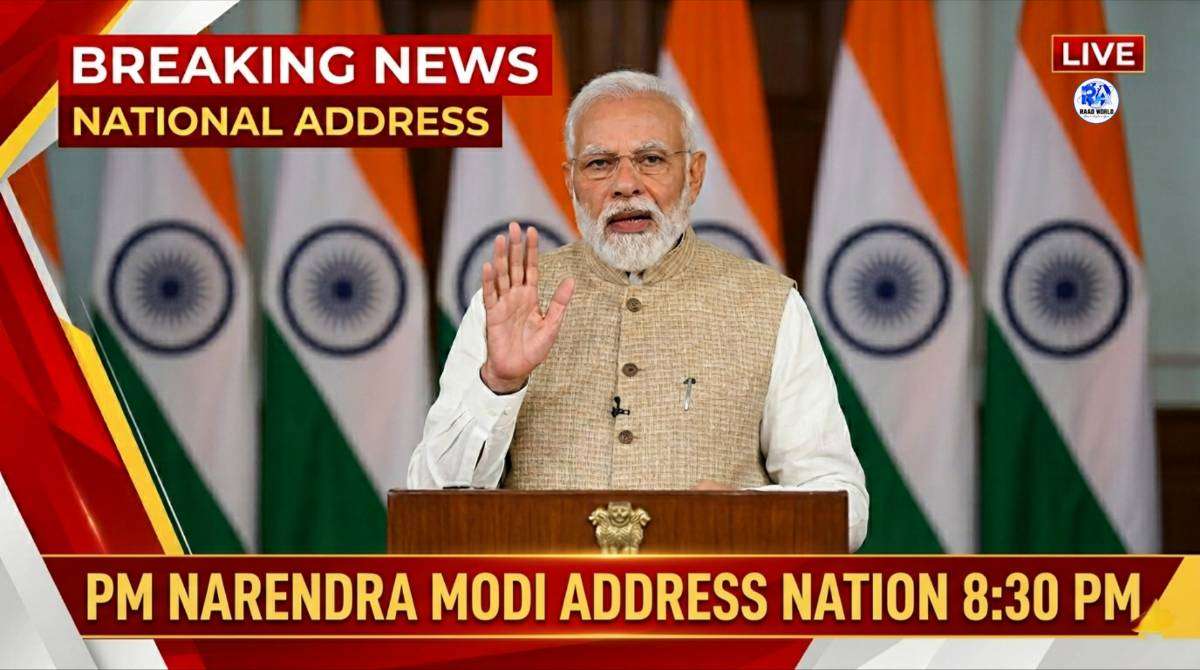 Prime Minister Narendra Modi addressing the nation at 8:30 PM with Indian flags in the background during a live national broadcast